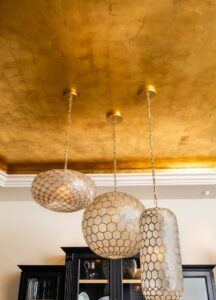 Gold leaf gilding wall finish adding luxury and depth to interior space